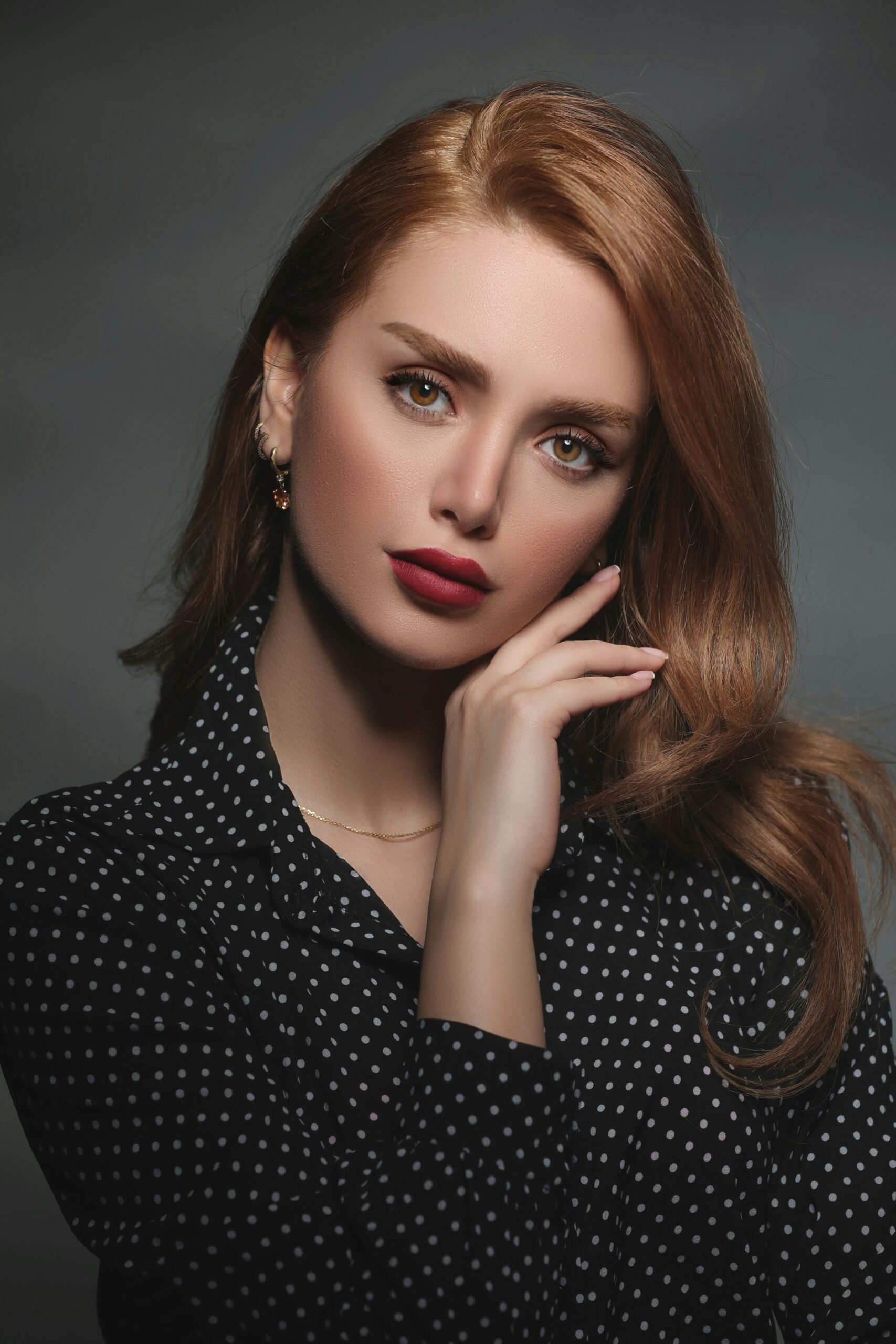 A redheaded woman in a red suit